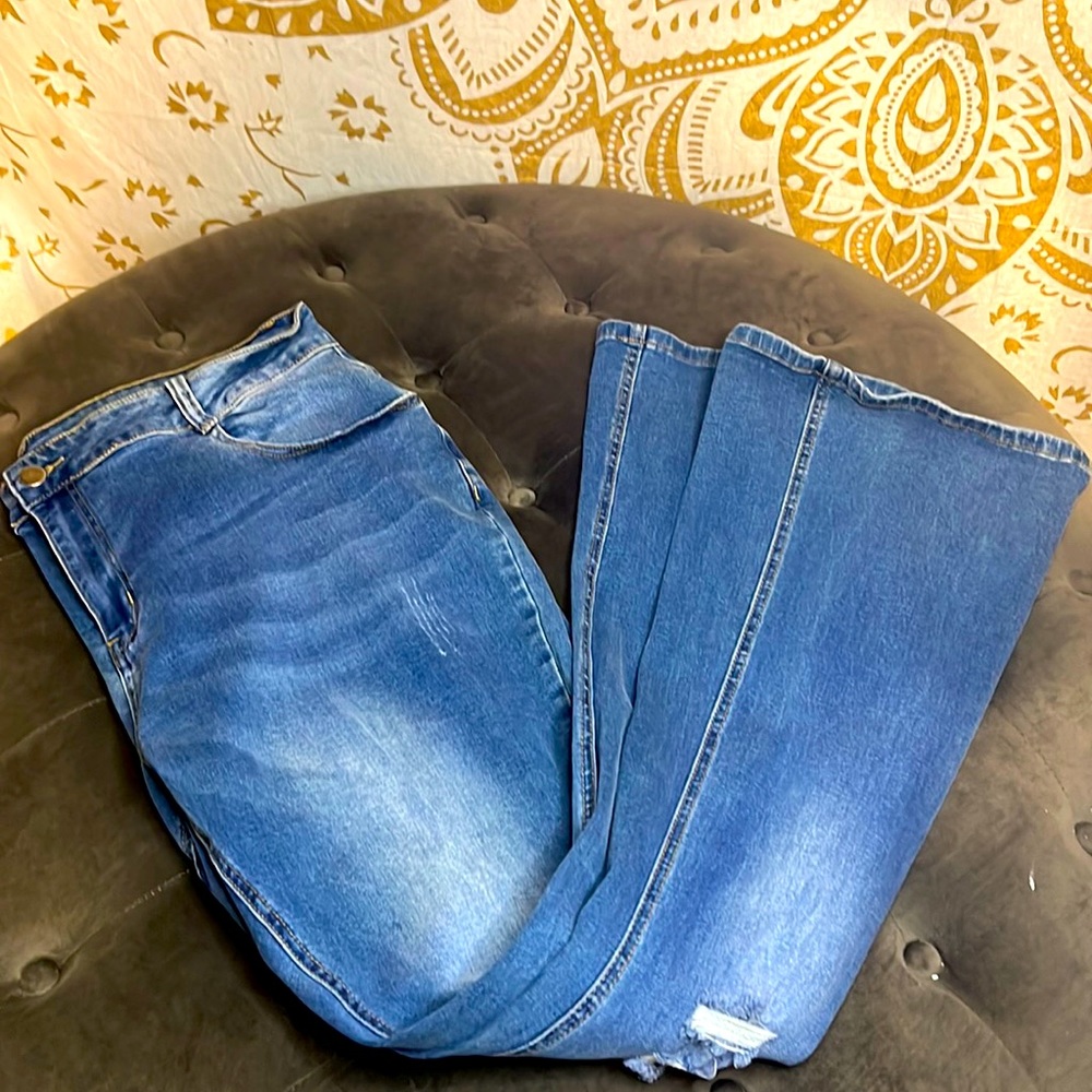 Light blue denim bellbottoms/boot cut with two small factory rips